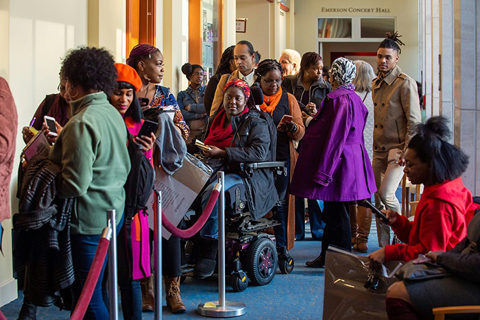 A long line of community members wait to see Nikki Giovanni